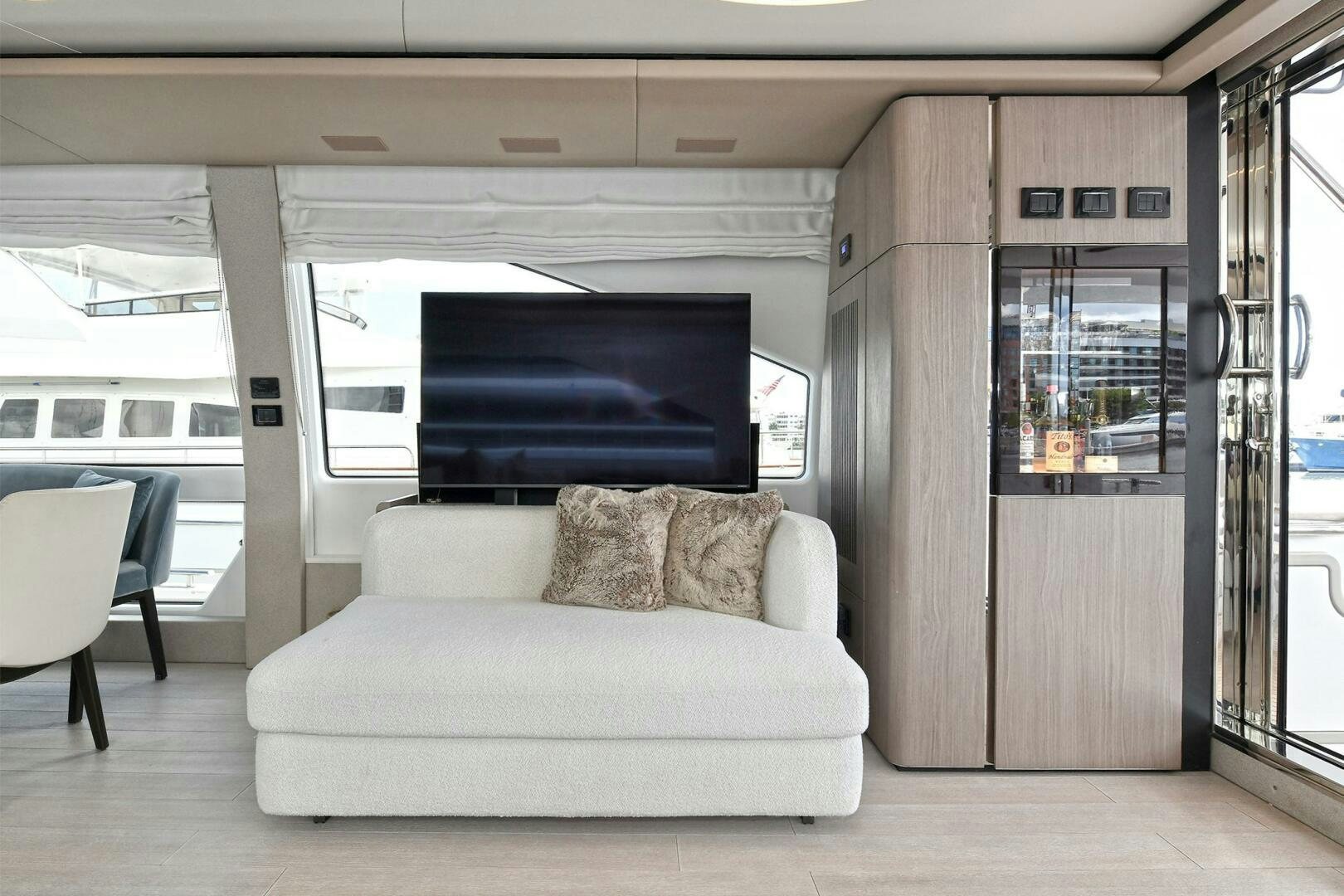 a living room with a large screen aboard SLAINTE Yacht for Sale