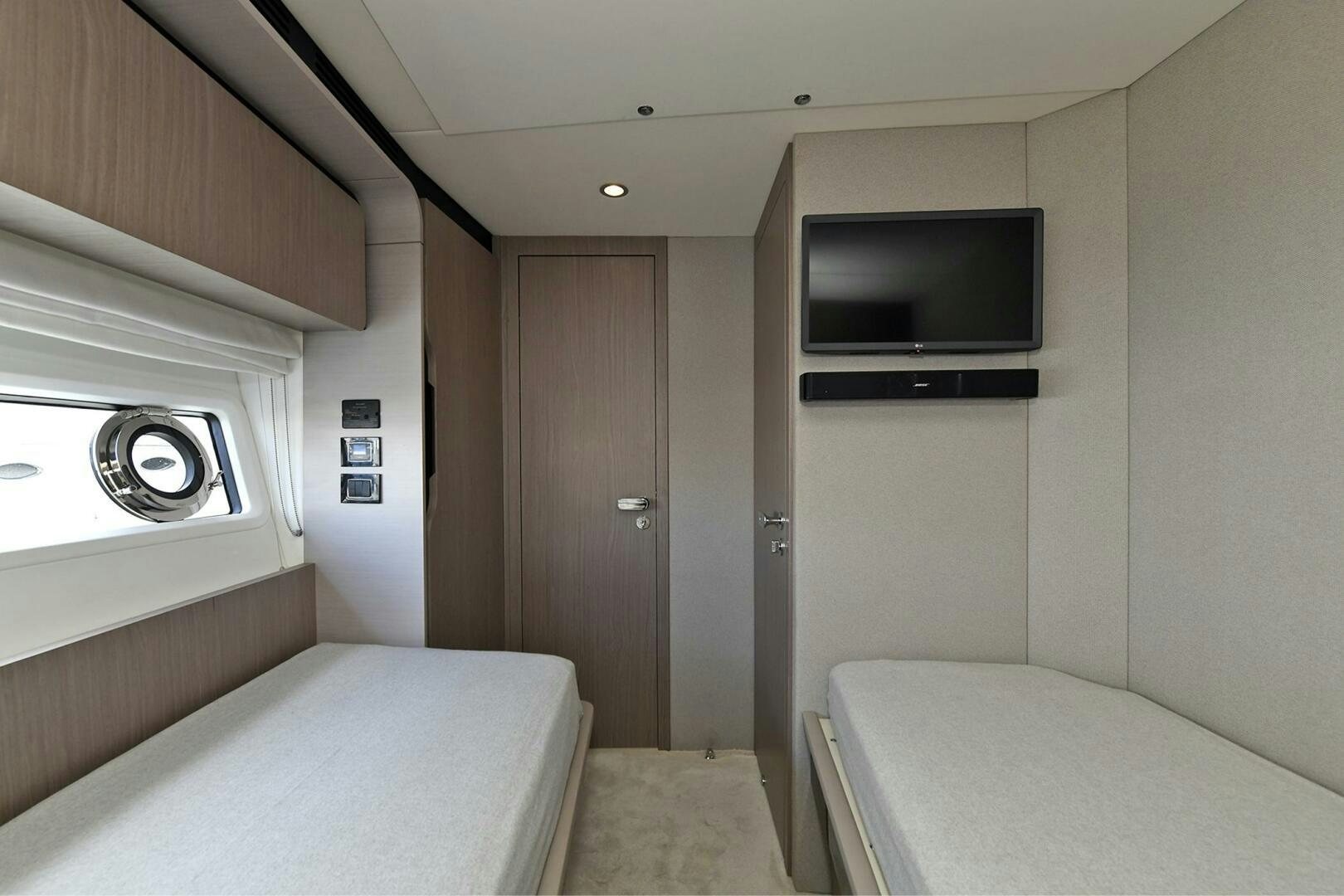 a bedroom with a bed and a tv aboard SLAINTE Yacht for Sale