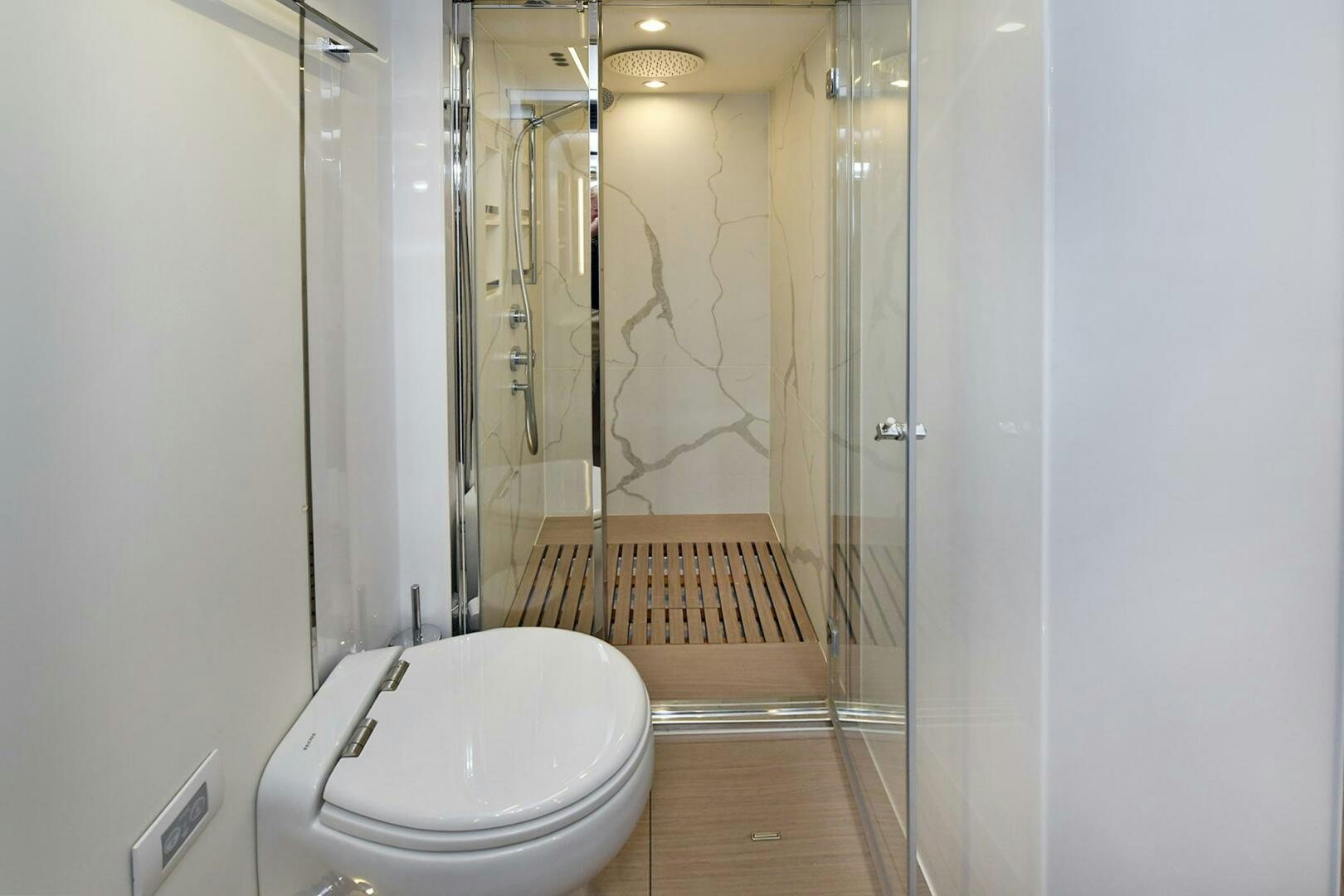 a bathroom with a toilet and a shower aboard SLAINTE Yacht for Sale