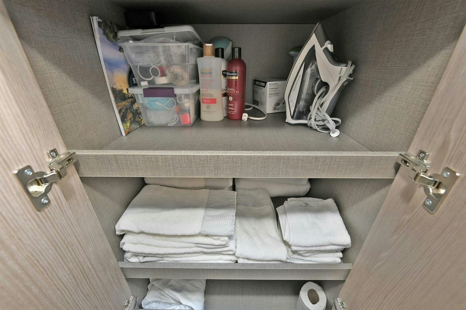a shelf with clothes and toiletries aboard SLAINTE Yacht for Sale