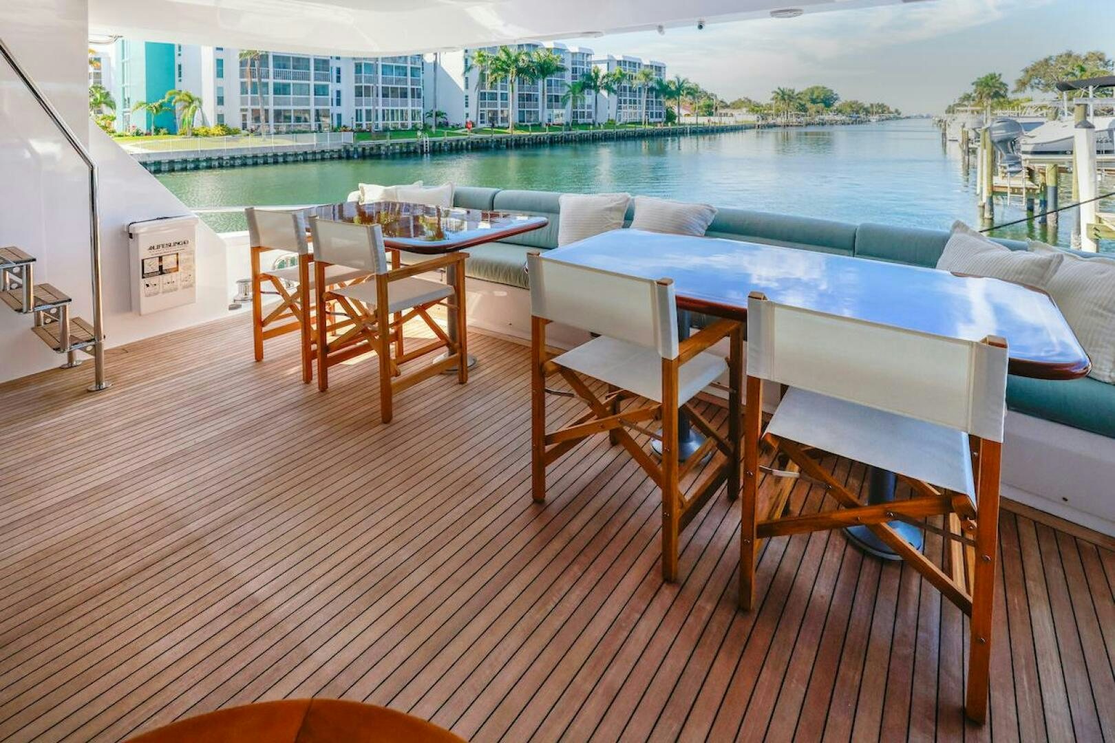 a deck with a table and chairs aboard NORTH COAST Yacht for Sale