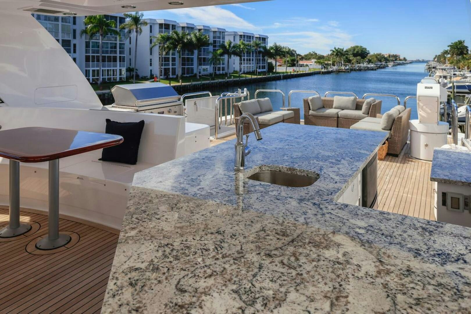 a patio with a table and chairs aboard NORTH COAST Yacht for Sale