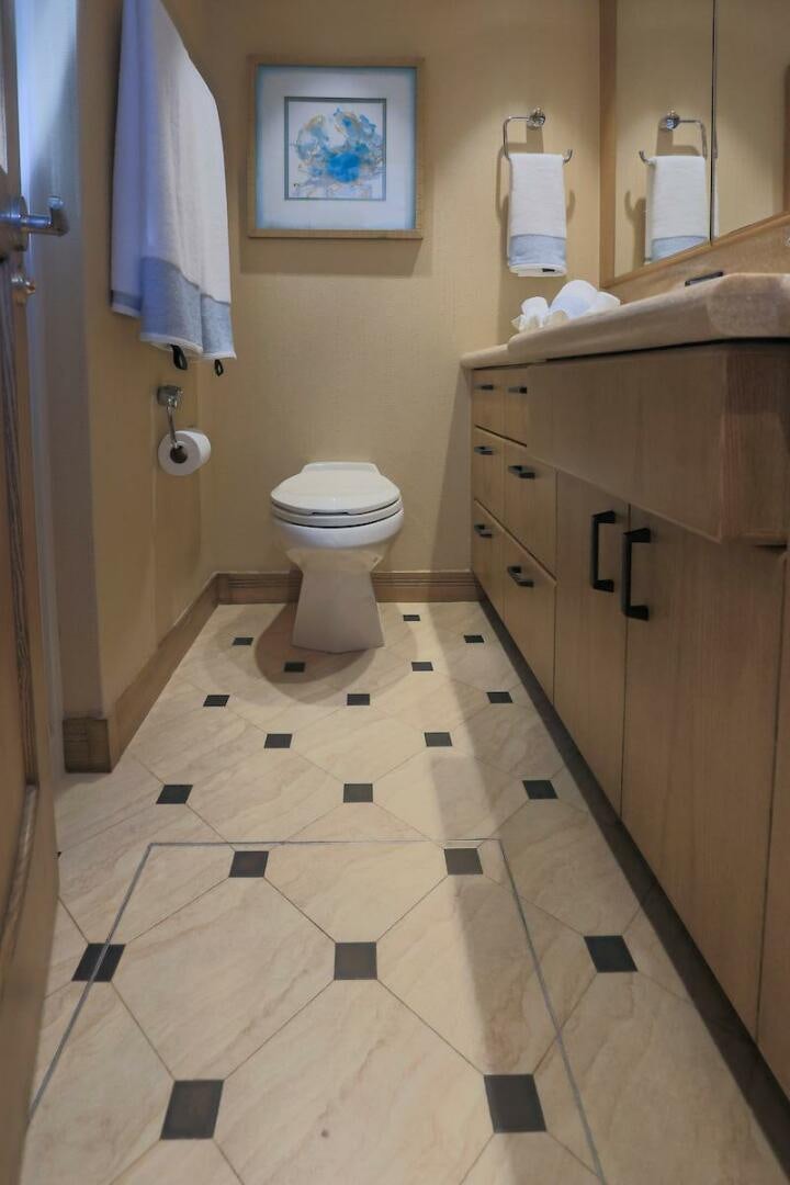 a bathroom with a toilet and a sink aboard NORTH COAST Yacht for Sale
