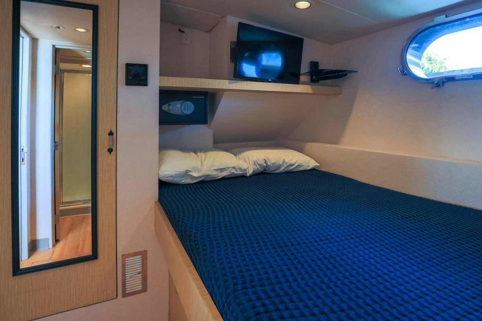 a bed with a blue sheet aboard NORTH COAST Yacht for Sale