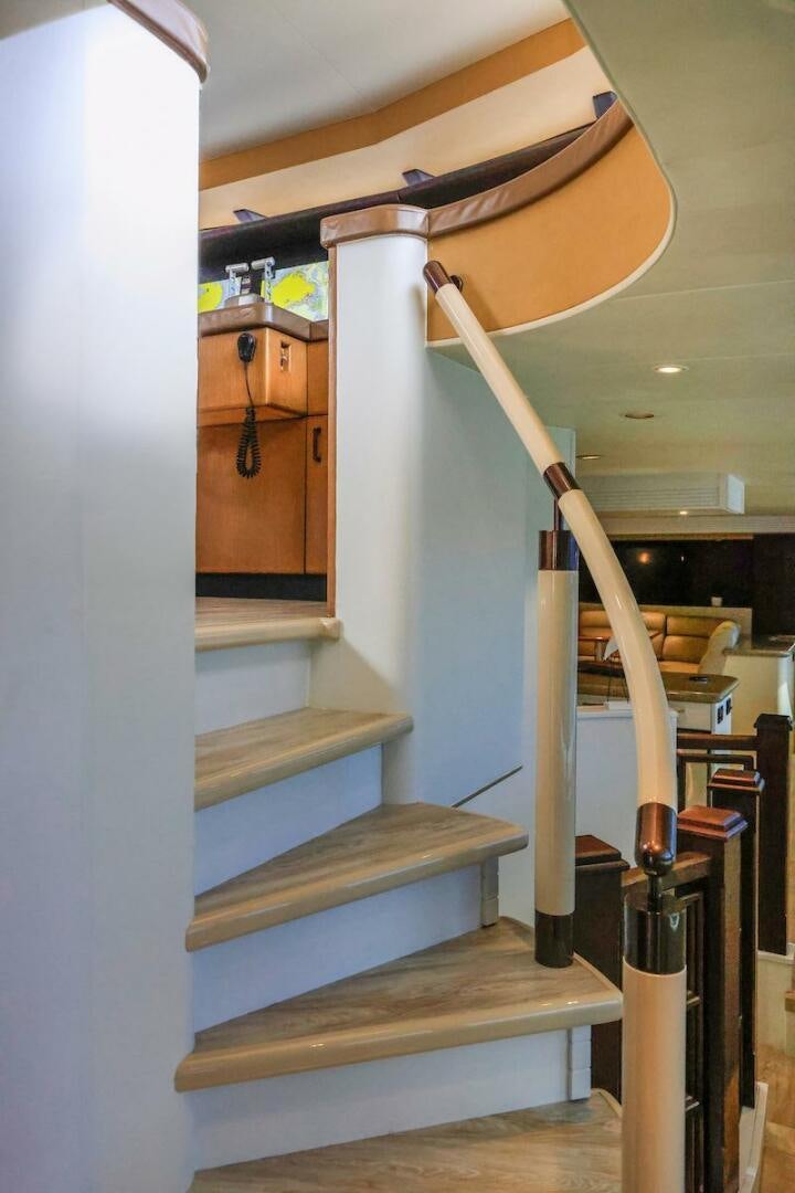 a white staircase with wooden railings aboard NORTH COAST Yacht for Sale