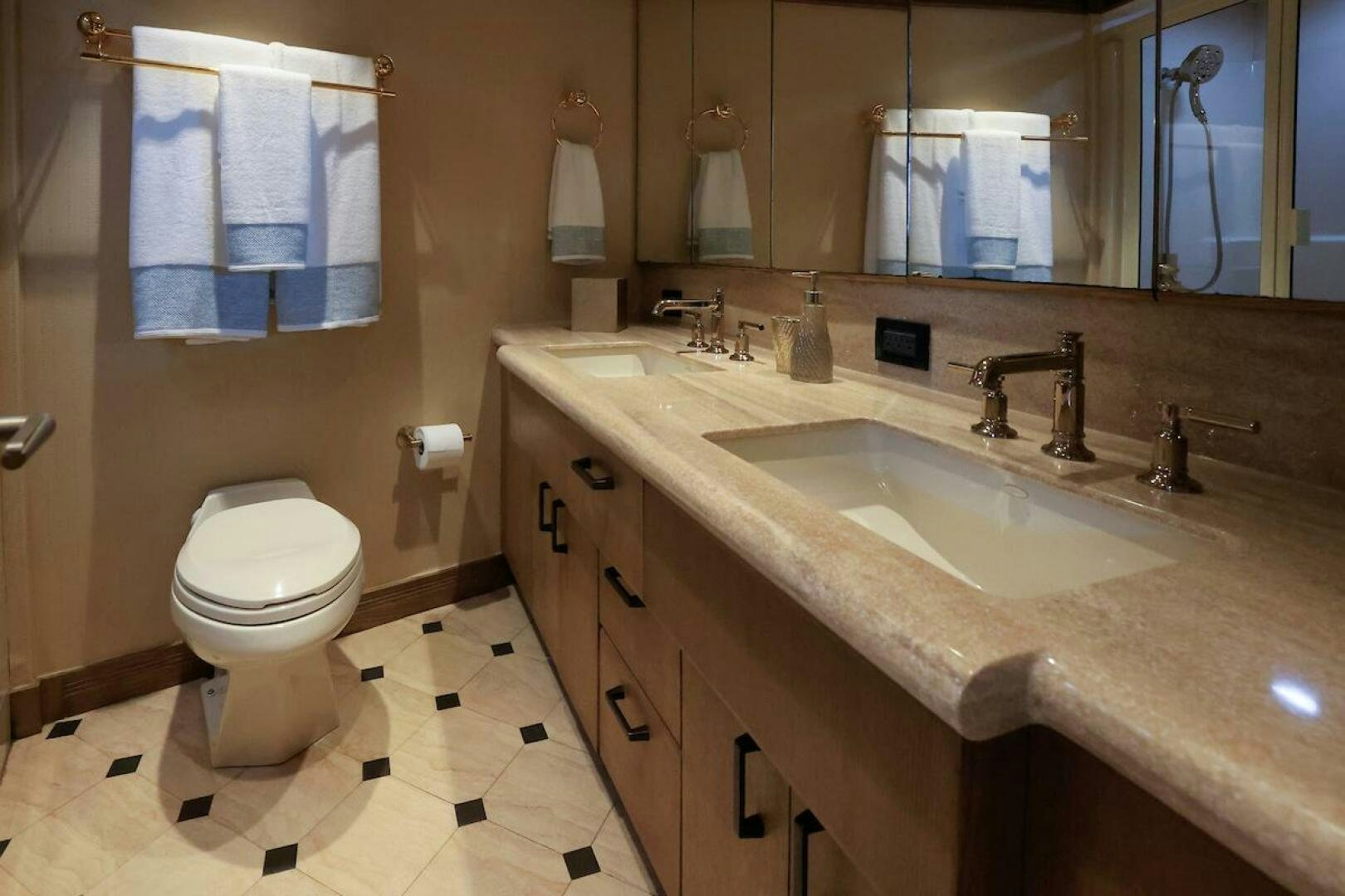 a bathroom with a sink toilet and a mirror aboard NORTH COAST Yacht for Sale