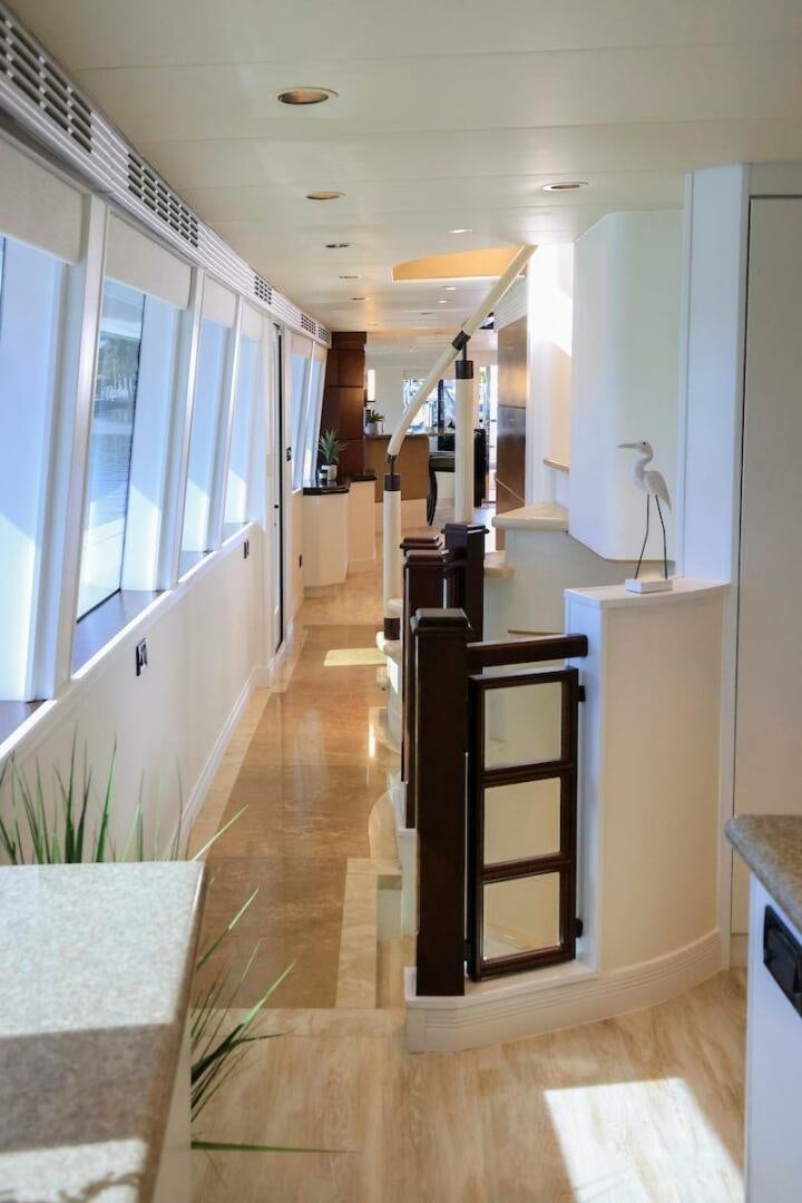 a hallway with a black cabinet and white walls aboard NORTH COAST Yacht for Sale