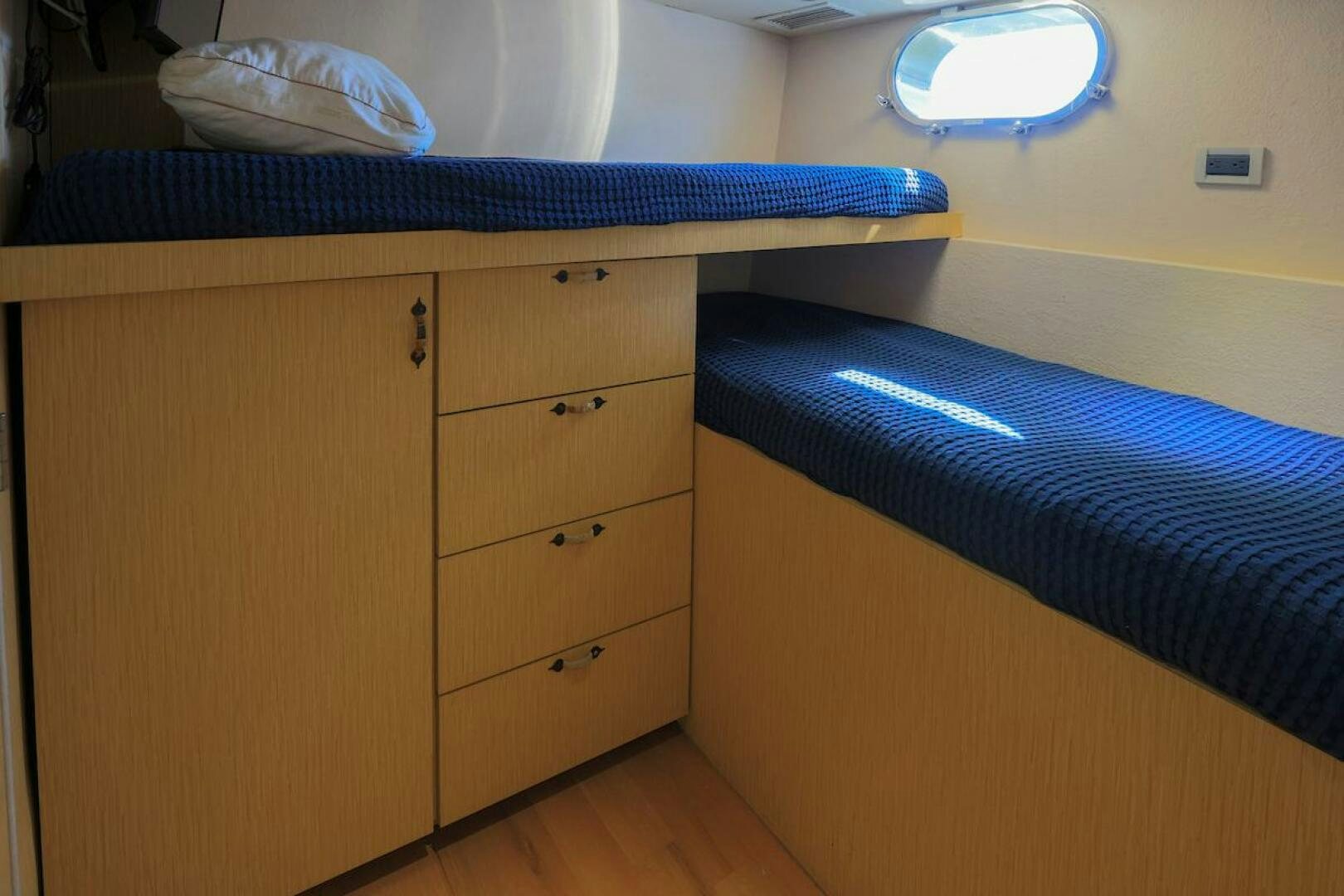 a bed and a dresser in a room aboard NORTH COAST Yacht for Sale