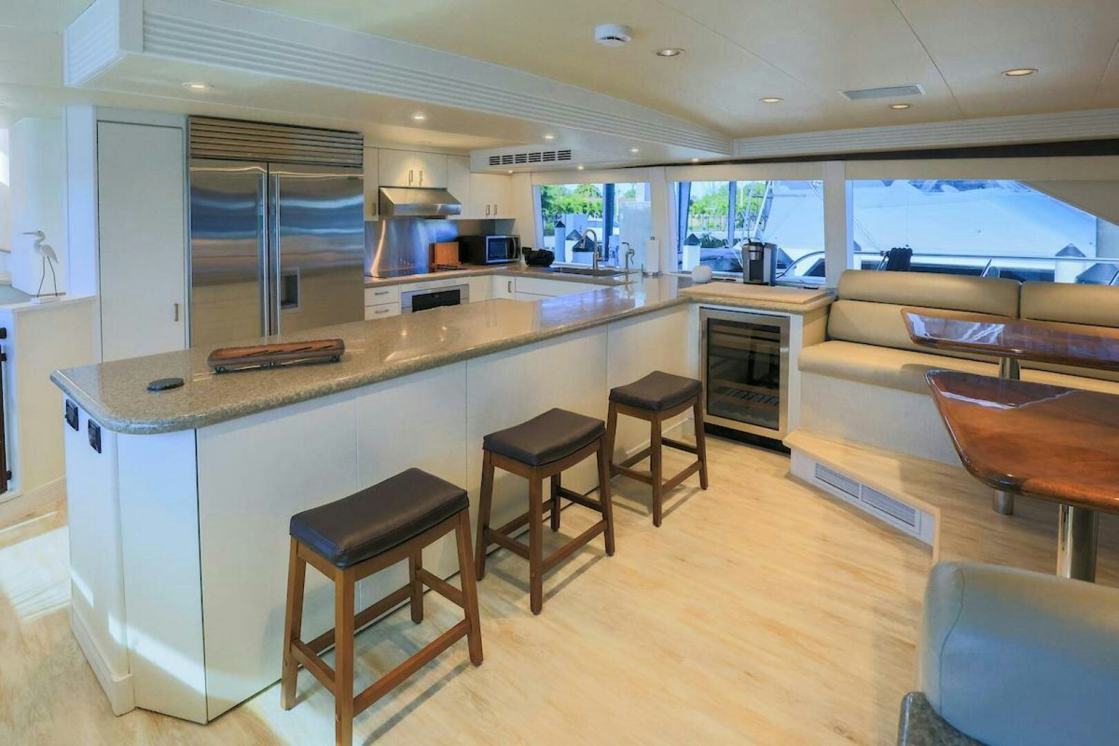 a kitchen with stools and tables aboard NORTH COAST Yacht for Sale
