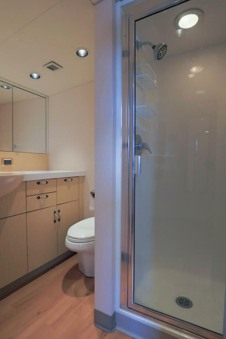 a bathroom with a shower unit and toilet aboard NORTH COAST Yacht for Sale