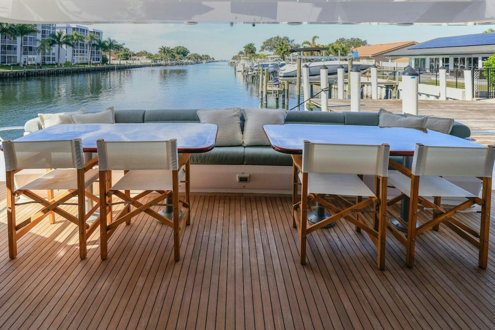 a deck with chairs and tables aboard NORTH COAST Yacht for Sale