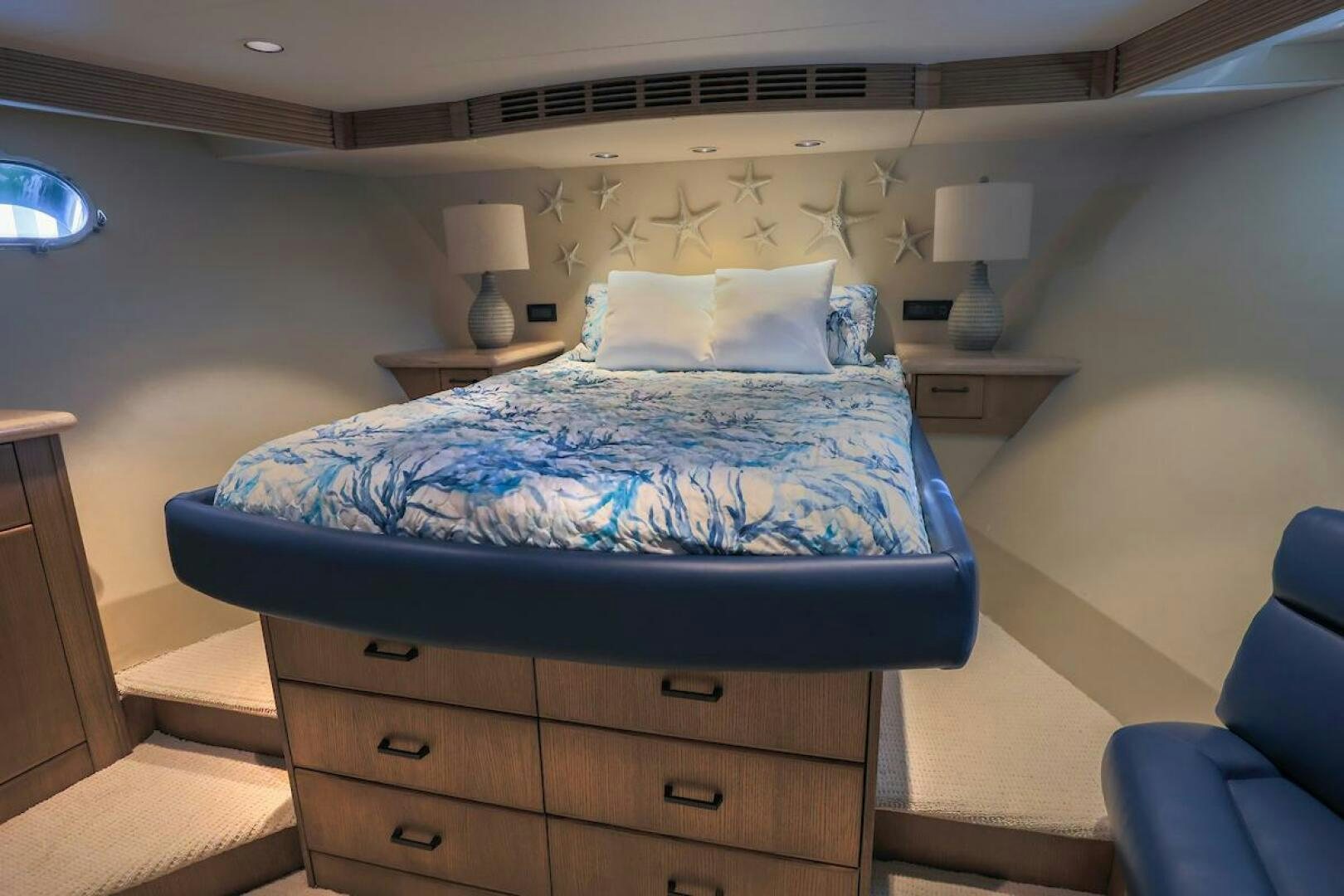 a bed with a blue comforter aboard NORTH COAST Yacht for Sale