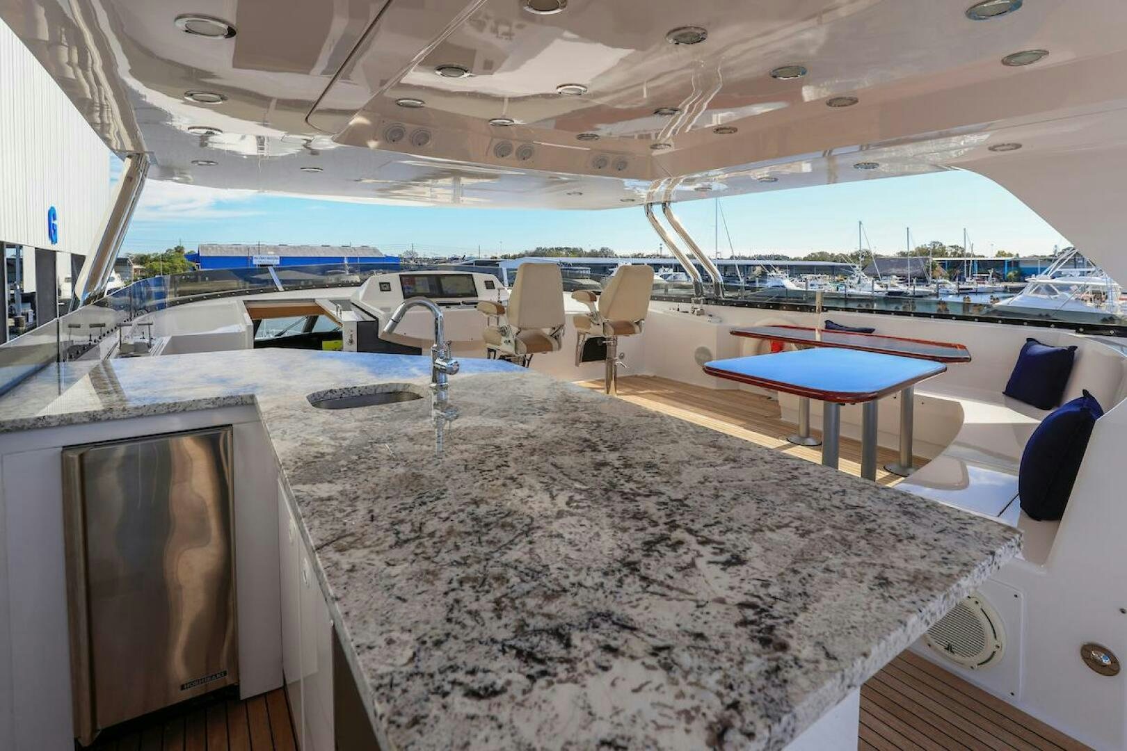 a large room with a table and chairs aboard NORTH COAST Yacht for Sale