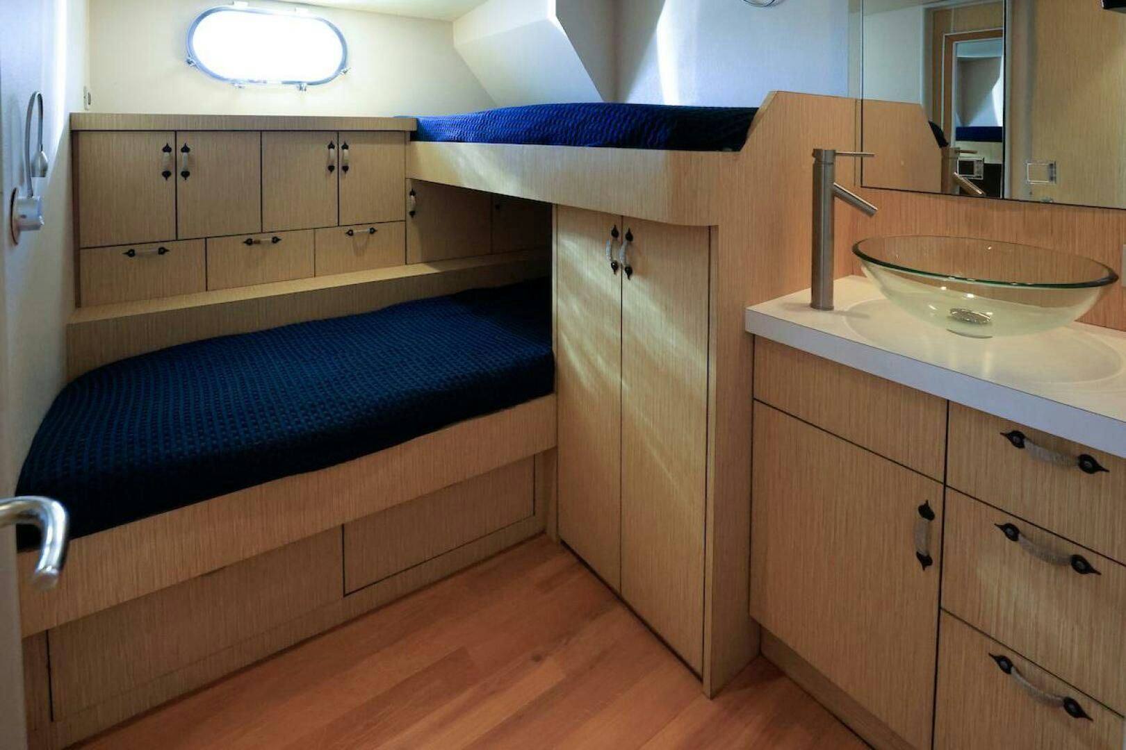 a bathroom with a sink and a bed aboard NORTH COAST Yacht for Sale