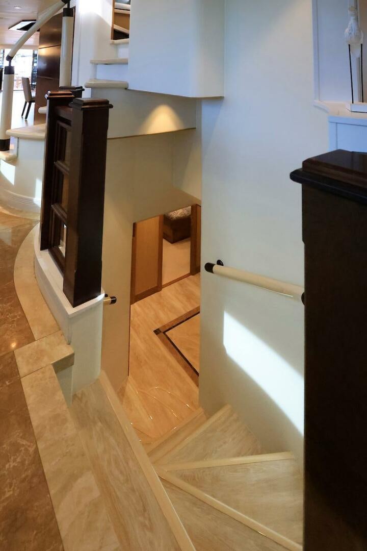 a room with a tv and a shelf with a wood floor aboard NORTH COAST Yacht for Sale