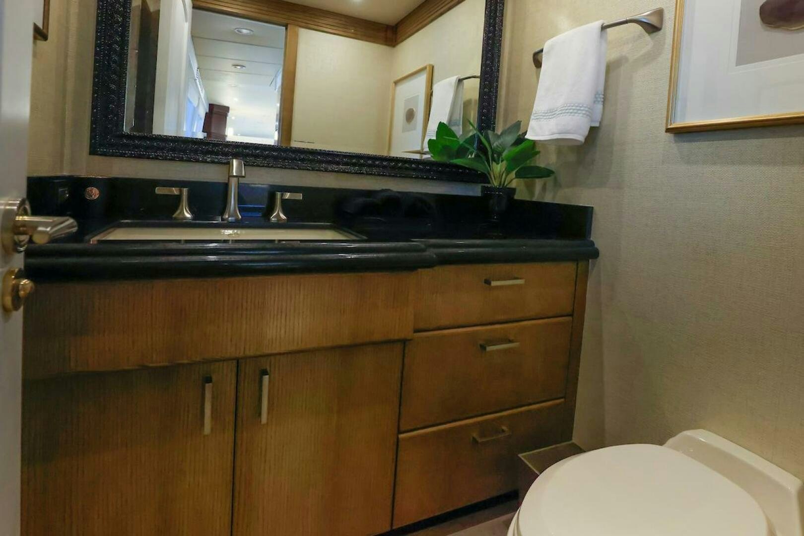 a bathroom with a sink and a mirror aboard NORTH COAST Yacht for Sale