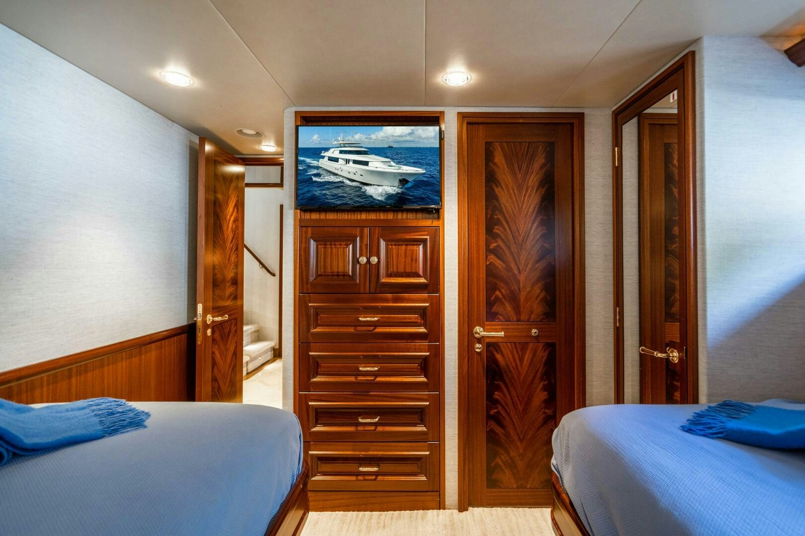 a bedroom with a bed and a dresser aboard FIRST LIGHT Yacht for Sale