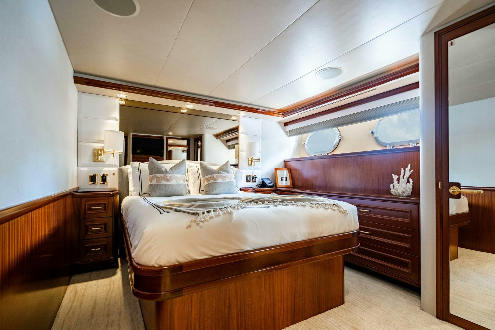 a bedroom with a bed and a mirror aboard FIRST LIGHT Yacht for Sale