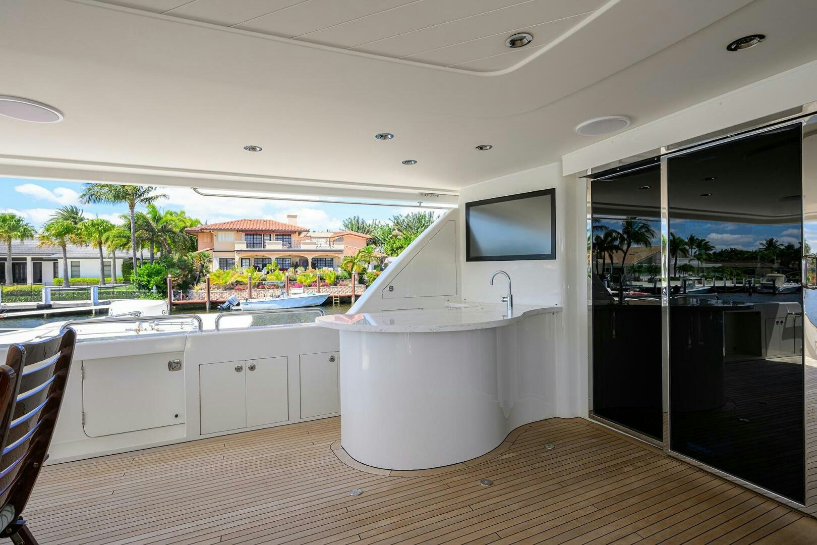 a room with a large window and a tv on the wall aboard FIRST LIGHT Yacht for Sale