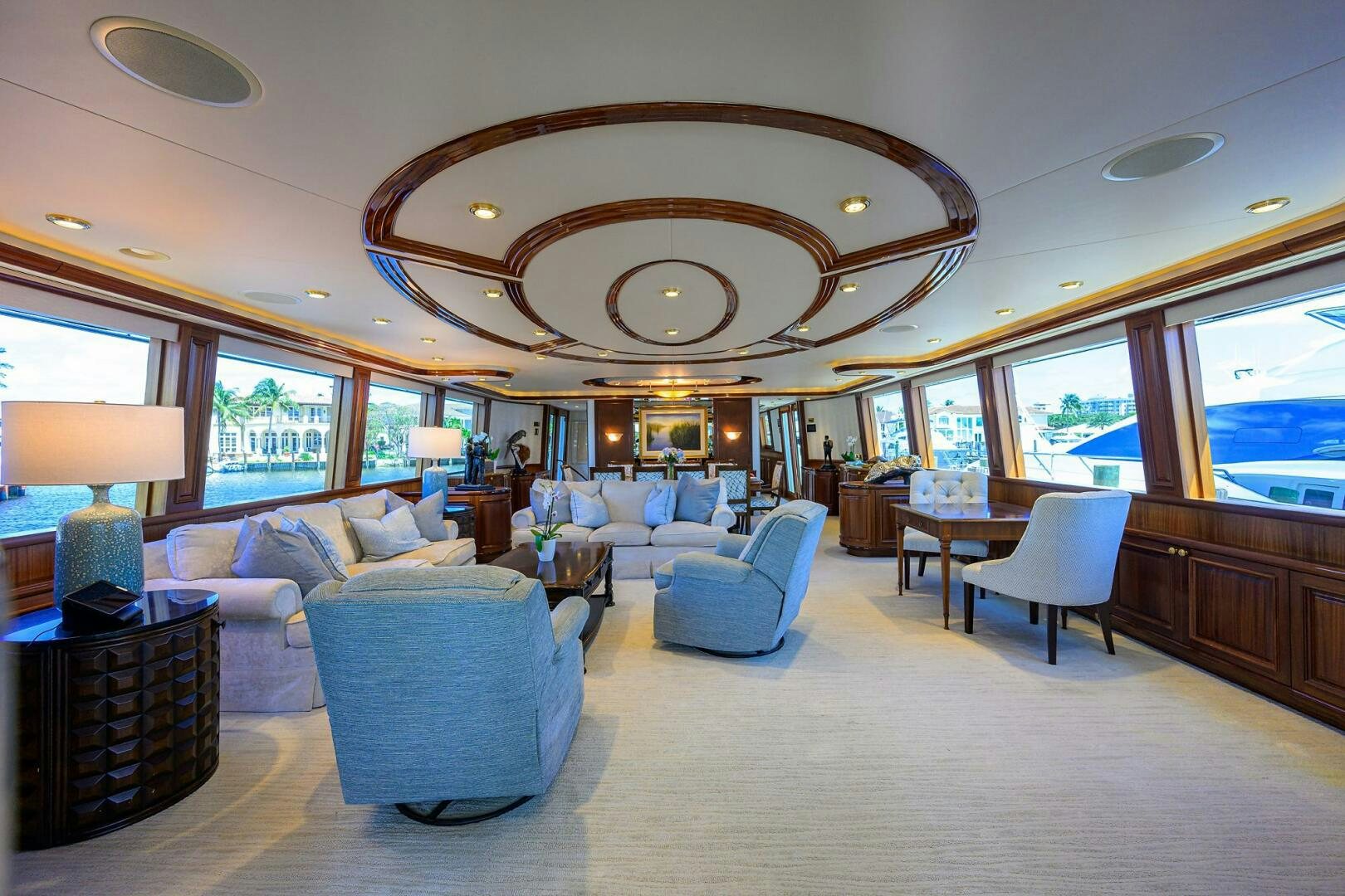 a large living room with a chandelier aboard FIRST LIGHT Yacht for Sale