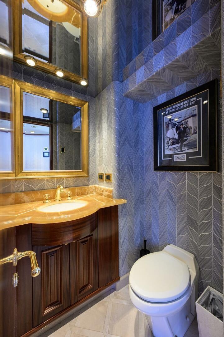 a bathroom with a blue wall aboard FIRST LIGHT Yacht for Sale