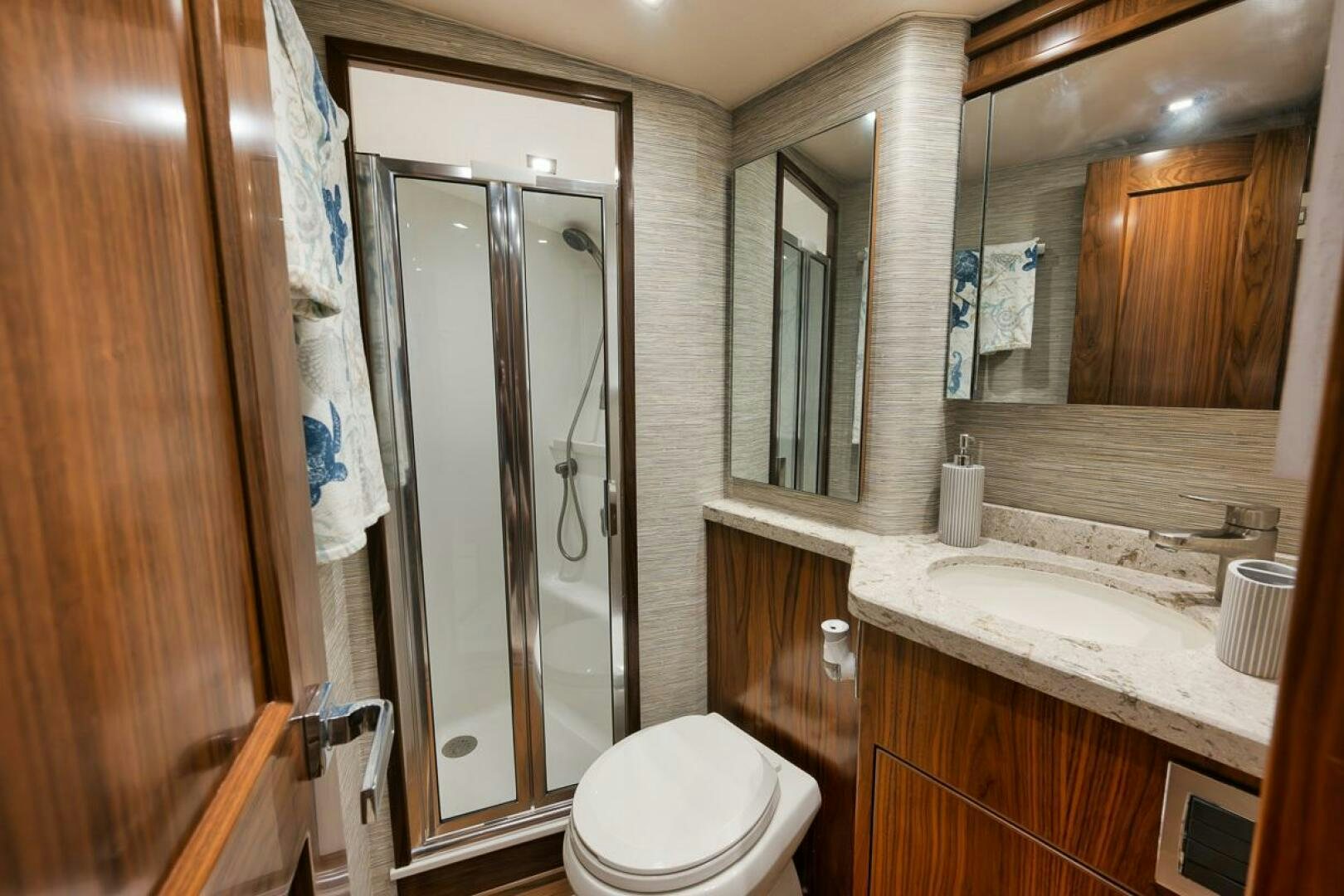 a bathroom with a glass shower door aboard JO-LI Yacht for Sale
