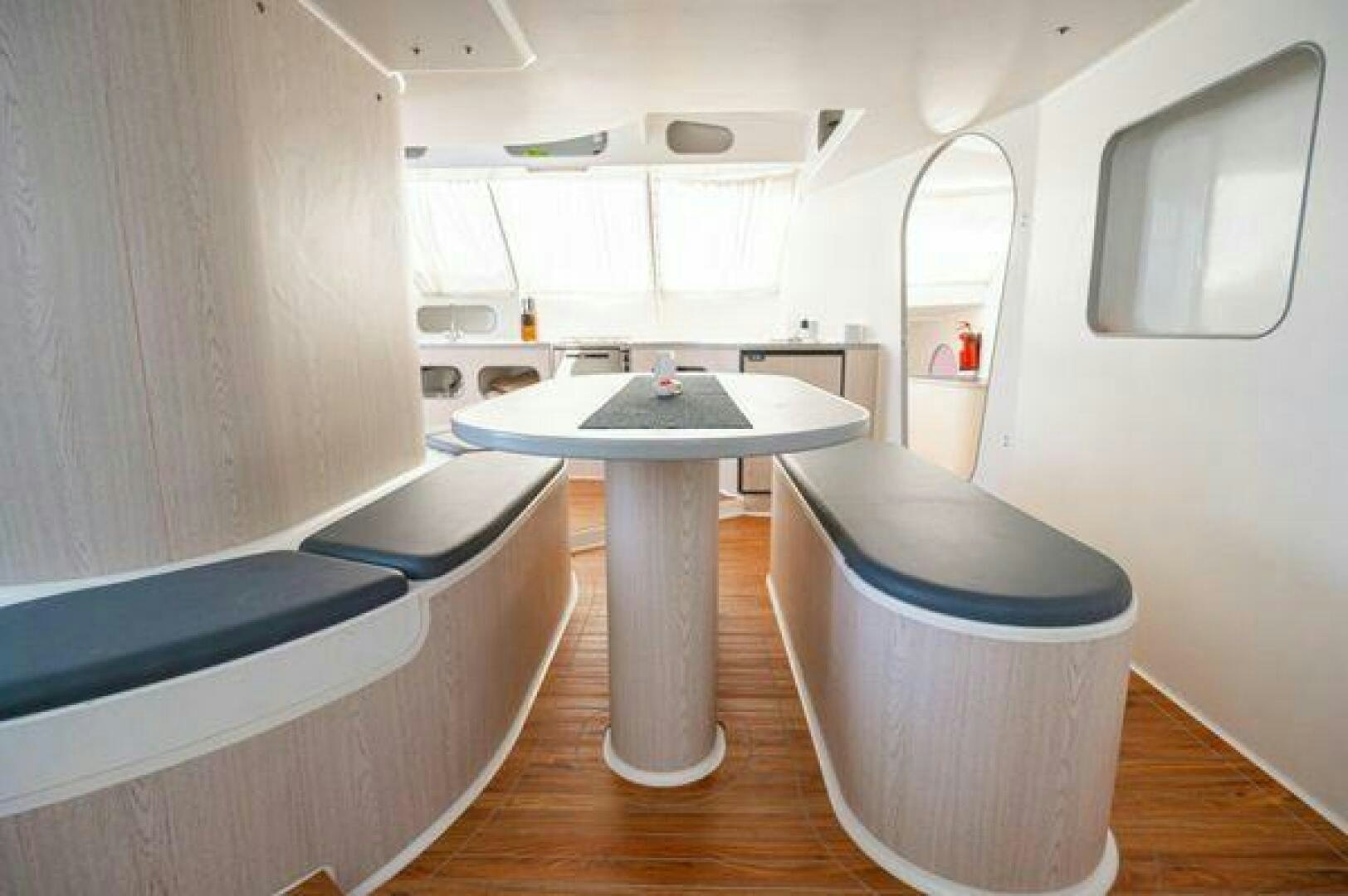 a room with a table and a bench aboard SEA CHANT Yacht for Sale