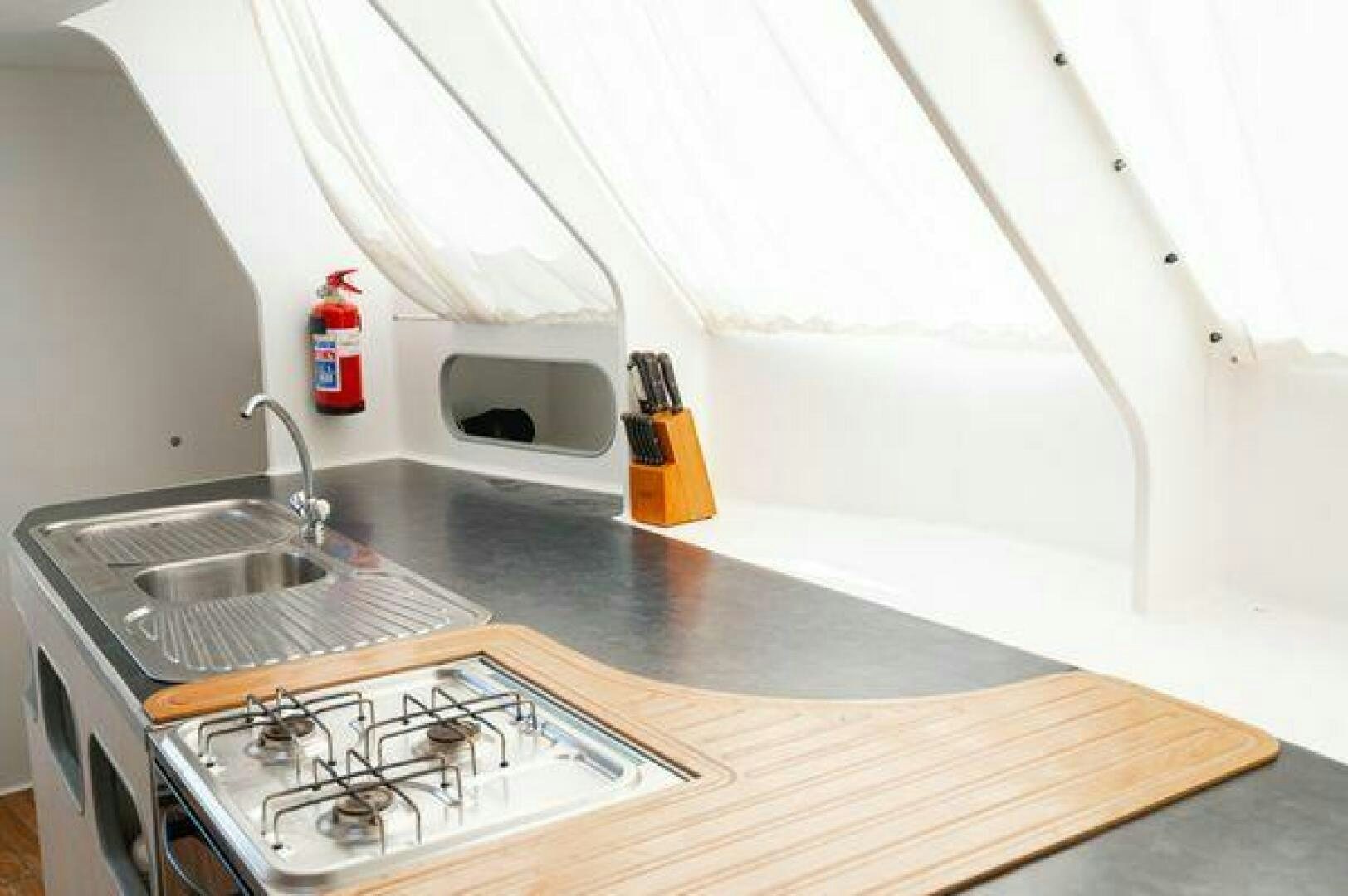 a kitchen with a sink and stove aboard SEA CHANT Yacht for Sale