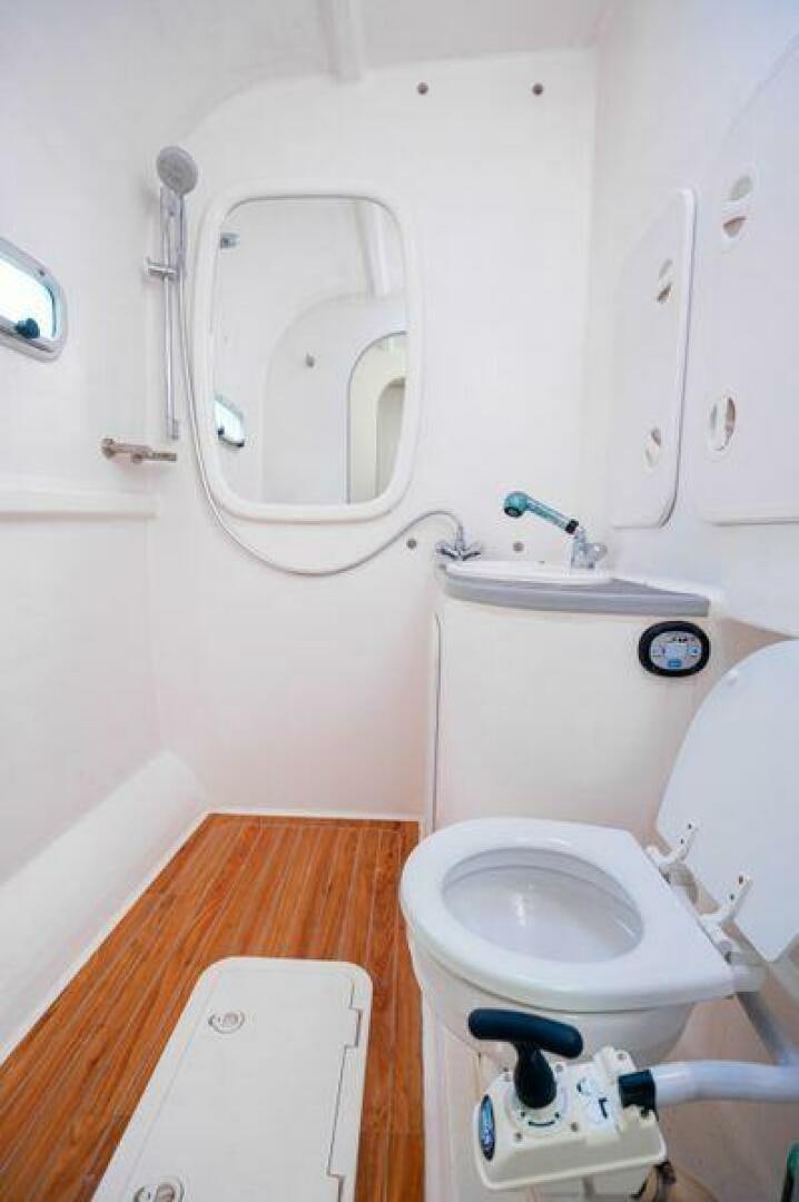 a toilet and washer in a bathroom aboard SEA CHANT Yacht for Sale