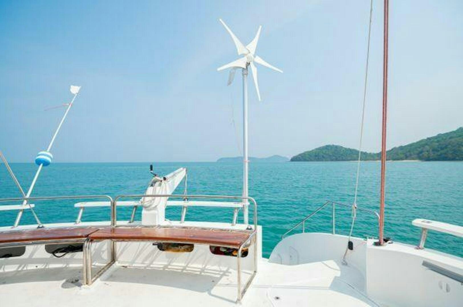 a boat with wind turbines on it aboard SEA CHANT Yacht for Sale
