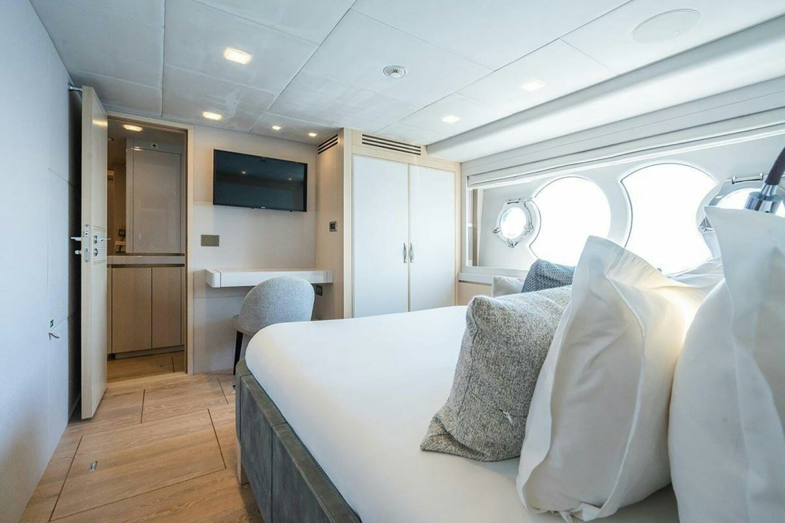 a room with a bed and a television aboard ROCCO Yacht for Sale