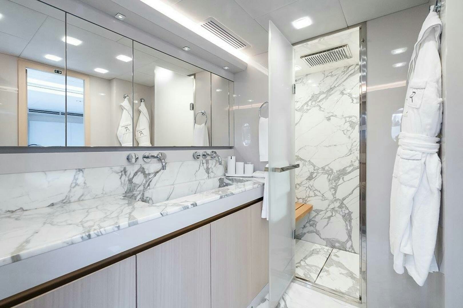 a bathroom with a large mirror aboard ROCCO Yacht for Sale