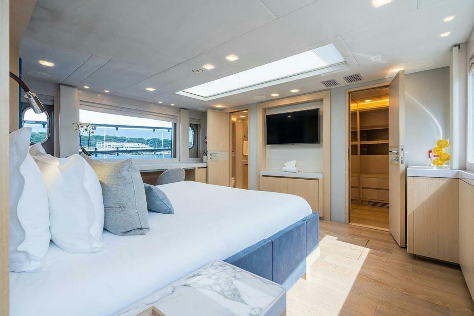a bedroom with a bed and a desk aboard ROCCO Yacht for Sale