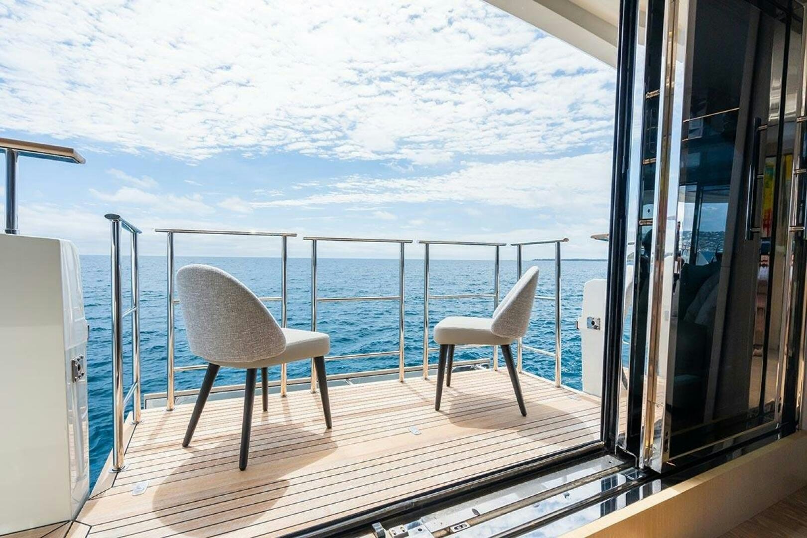 a balcony with a view of the ocean and the ocean aboard ROCCO Yacht for Sale