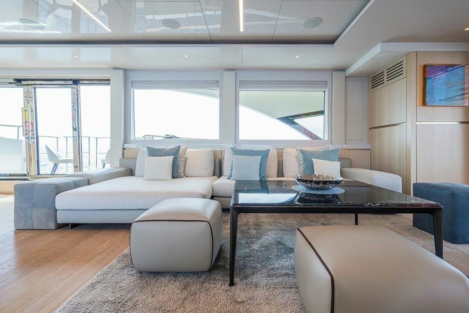 a living room with a table and couches aboard ROCCO Yacht for Sale