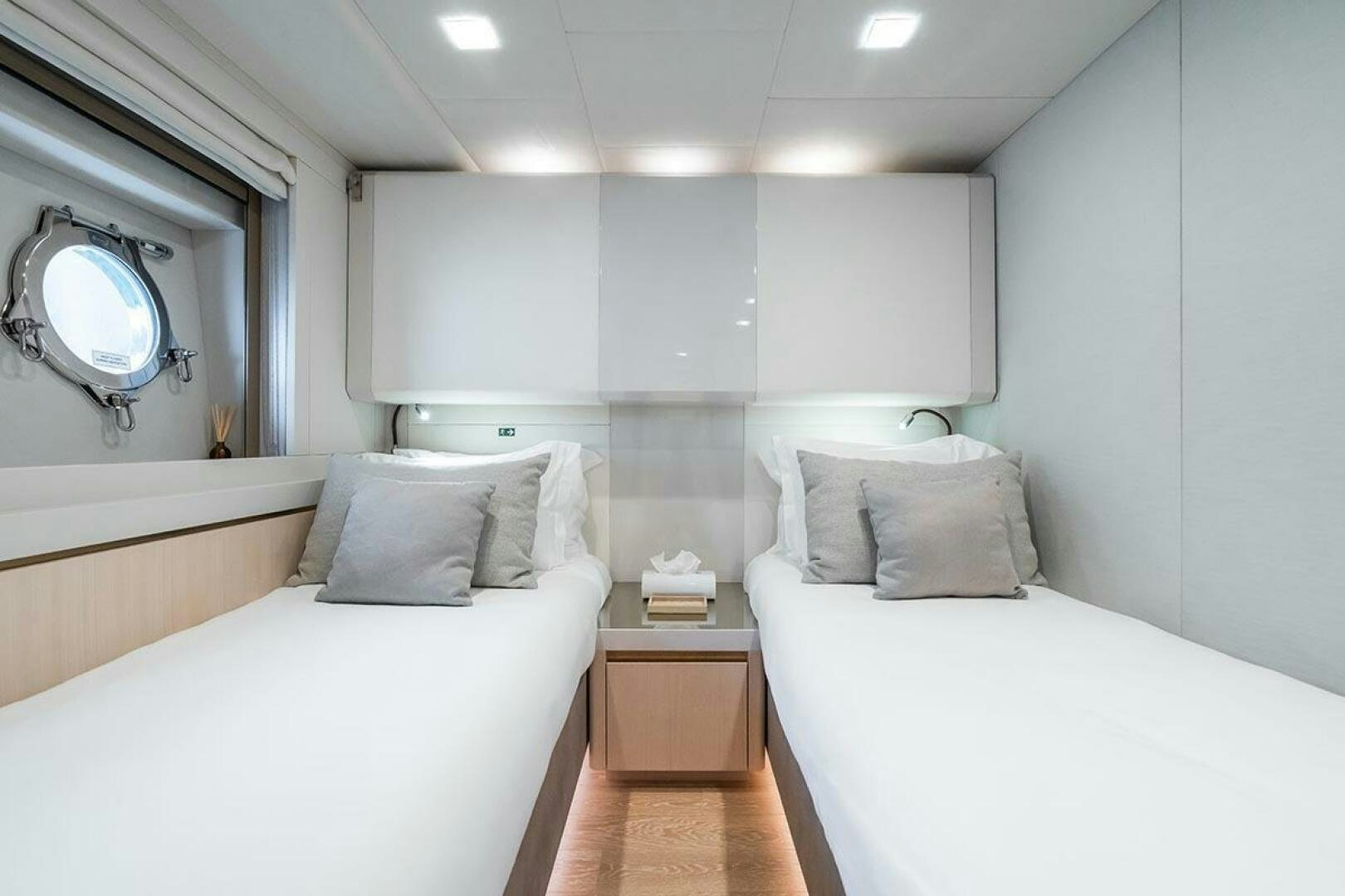 a room with two beds aboard ROCCO Yacht for Sale