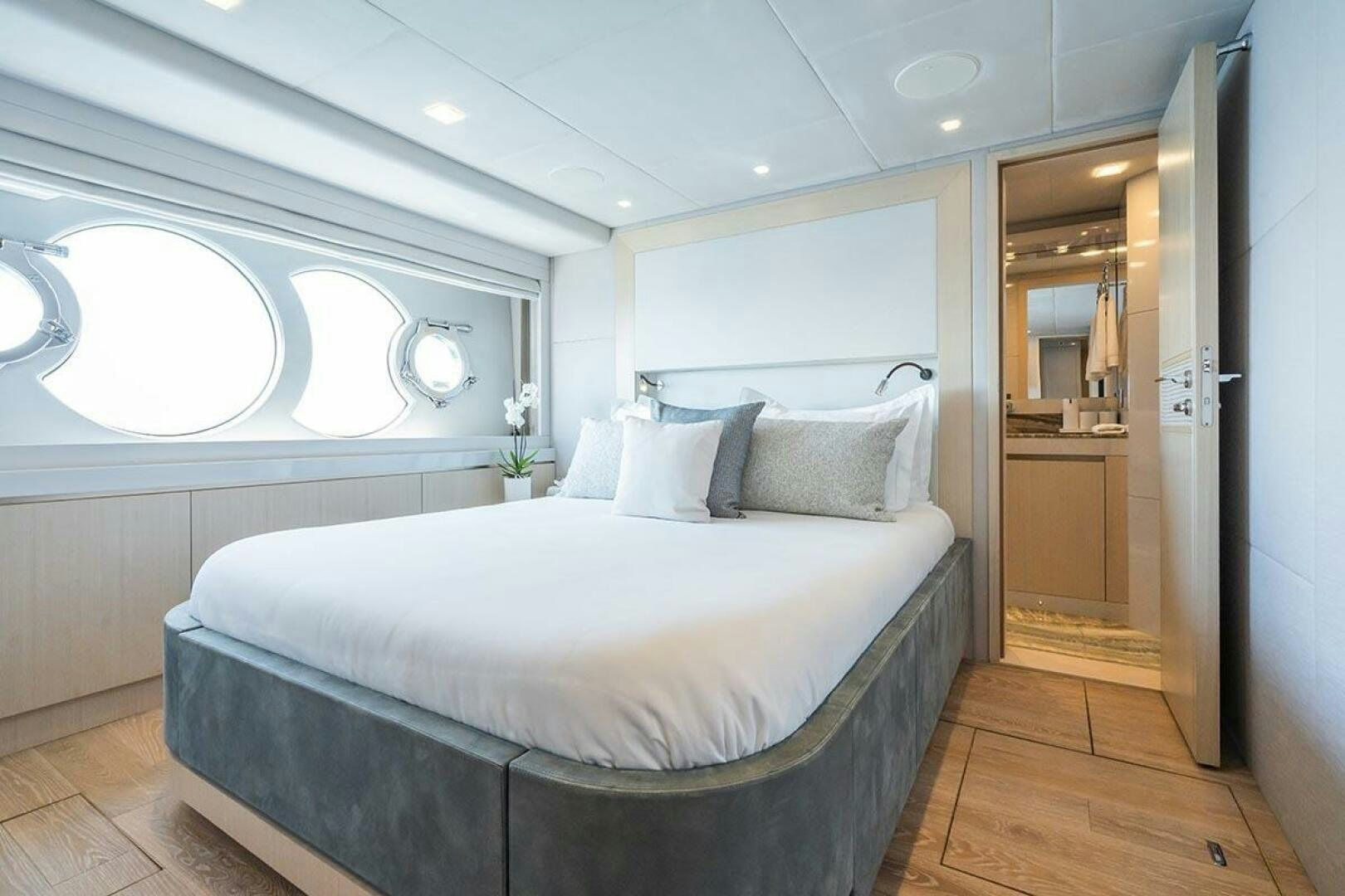 a room with a bed and a mirror aboard ROCCO Yacht for Sale