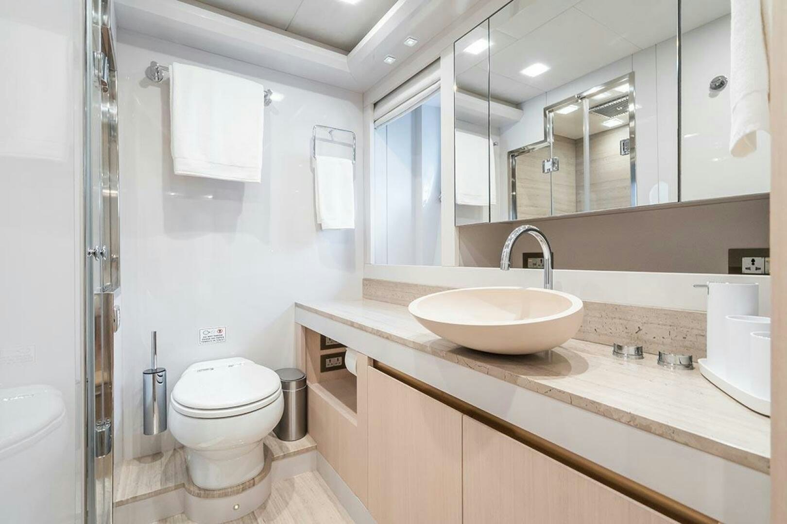 a bathroom with a sink toilet and a mirror aboard ROCCO Yacht for Sale