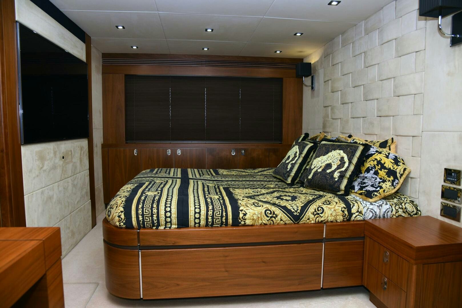 a bed with a blue and black blanket on it aboard SAVI II  Yacht for Sale