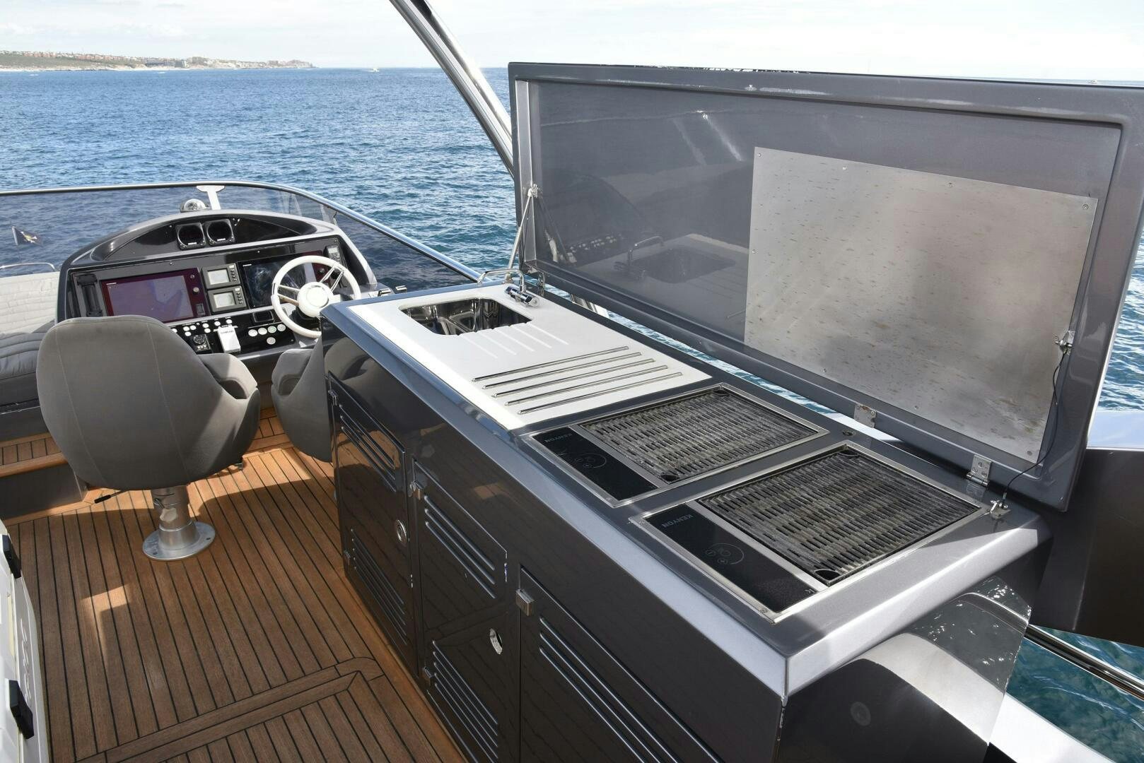 a deck with a large tv and a chair on it aboard SAVI II  Yacht for Sale
