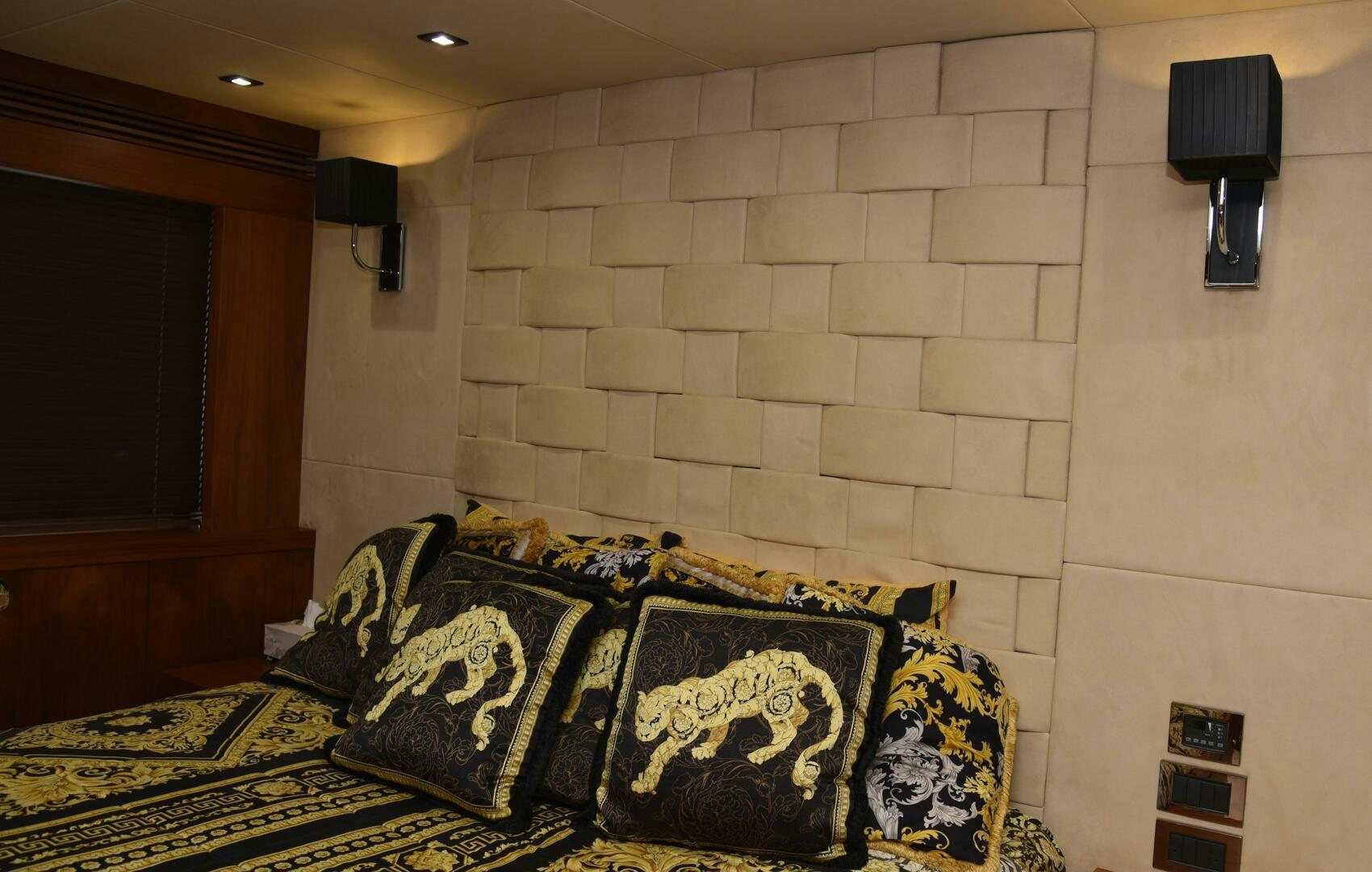 a room with a couch and a lamp on the wall aboard SAVI II  Yacht for Sale