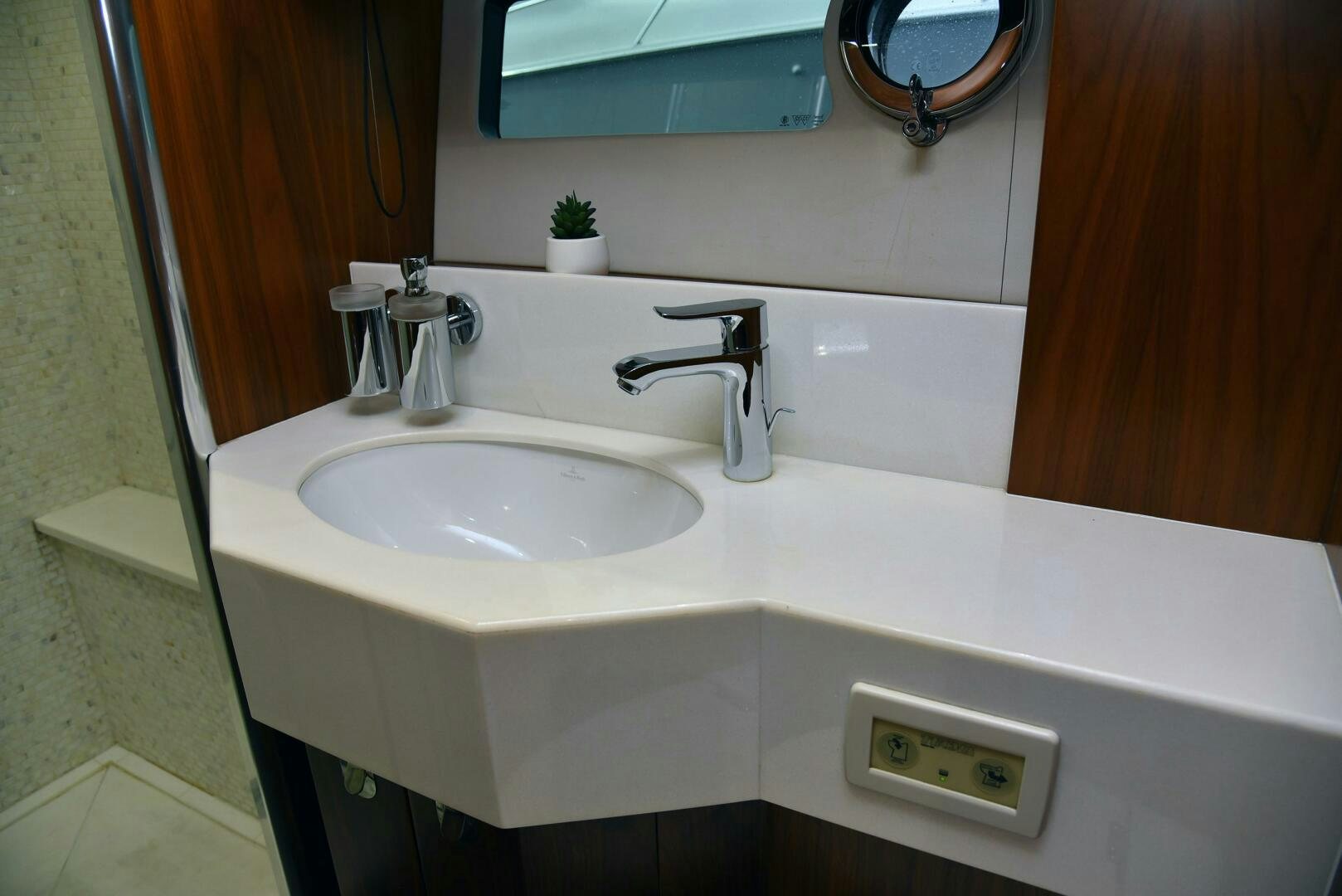 a bathroom sink with a mirror above it aboard SAVI II  Yacht for Sale