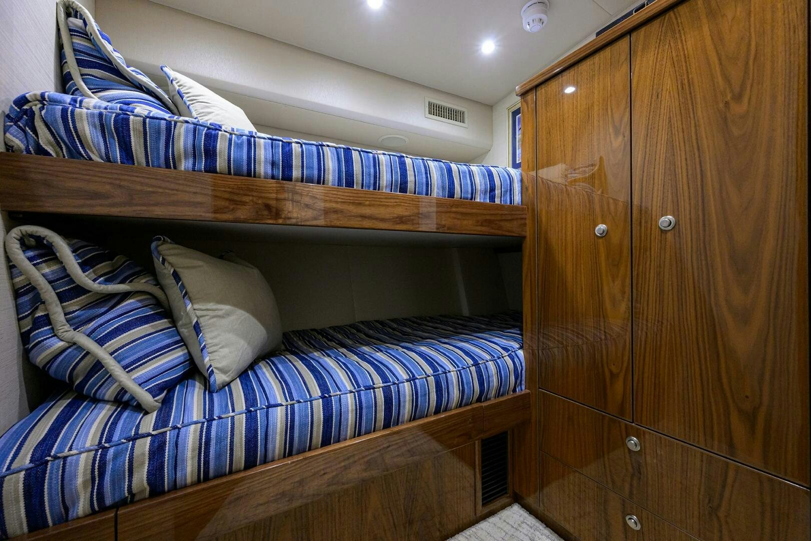 a bed with blue and white sheets aboard TAMI ANN Yacht for Sale