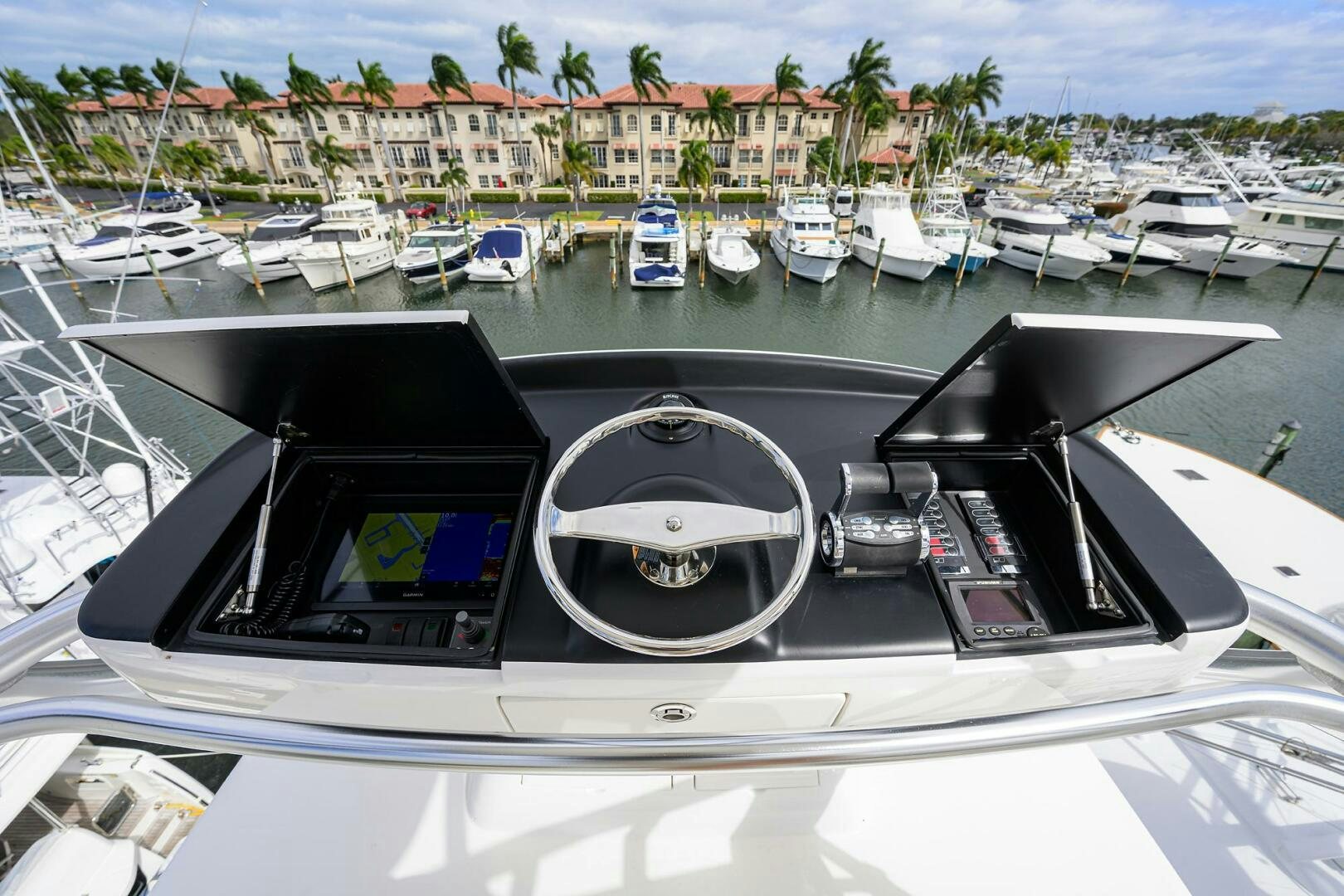 a car on a road with boats in the water aboard TAMI ANN Yacht for Sale