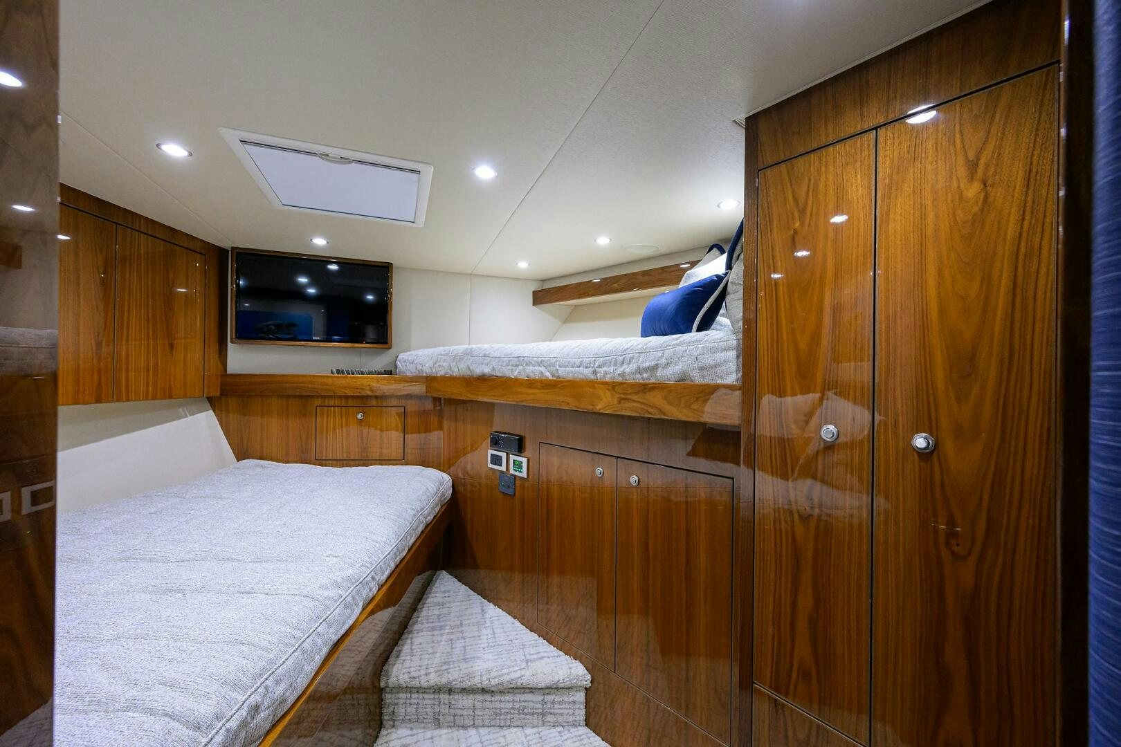 a room with a bed and a wood cabinet aboard TAMI ANN Yacht for Sale
