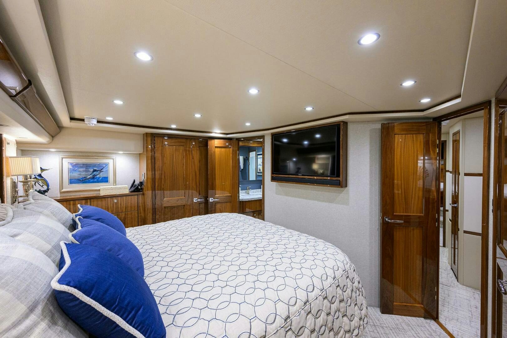 a bedroom with a bed and a television aboard TAMI ANN Yacht for Sale