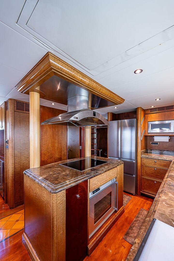 a kitchen with a steel stove aboard PREDATOR Yacht for Sale