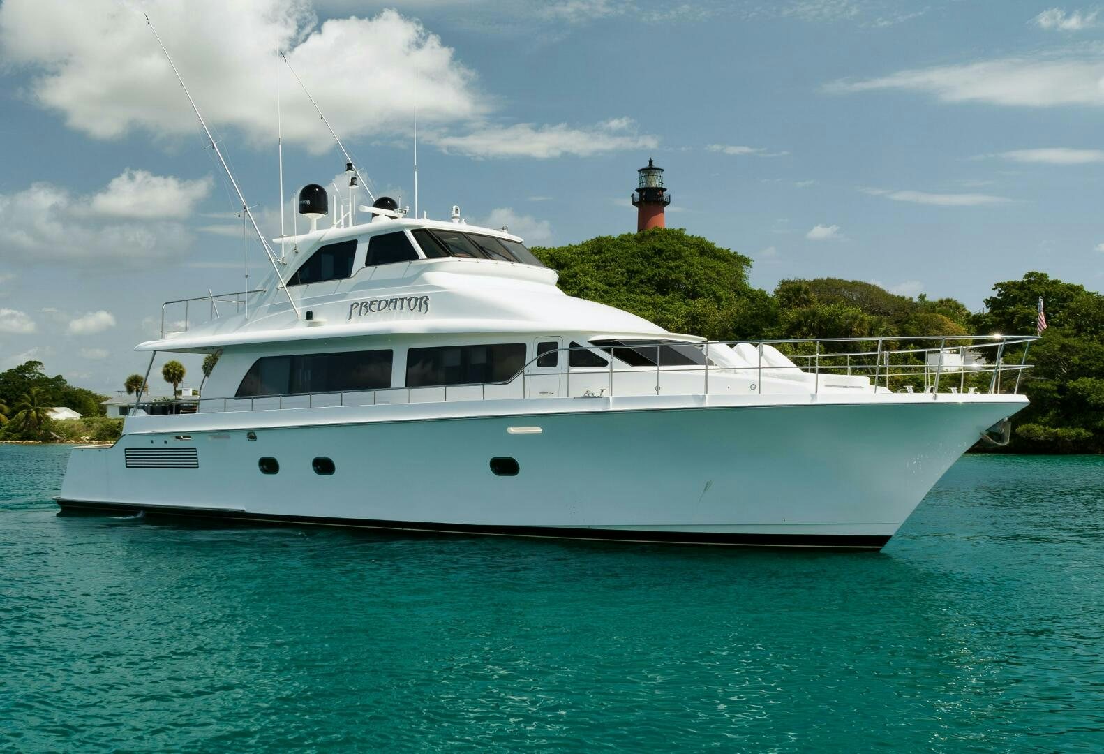 a white boat in the water aboard PREDATOR Yacht for Sale