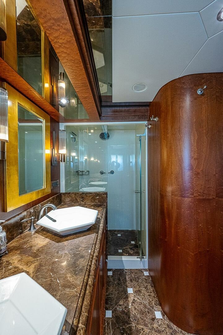 a bathroom with a sink and a mirror aboard PREDATOR Yacht for Sale