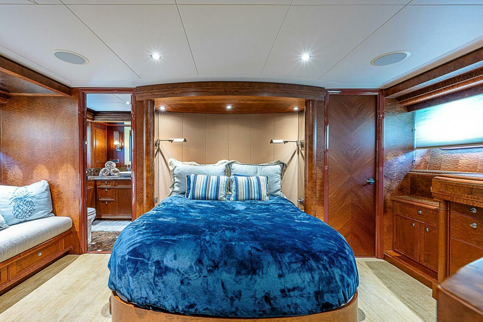 a bedroom with a bed and a dresser aboard PREDATOR Yacht for Sale